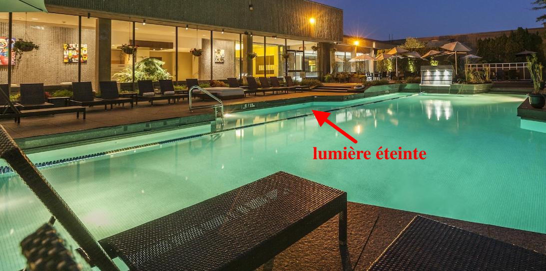 vue de la piscine avec une des lumières éteintes